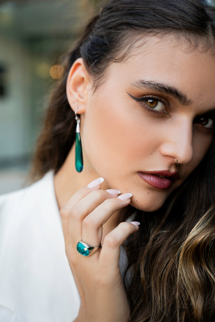 Model wearing jewelry earrings tourmaline quartz blue drop shape with the matching ring tourmaline quartz blue sterling silver