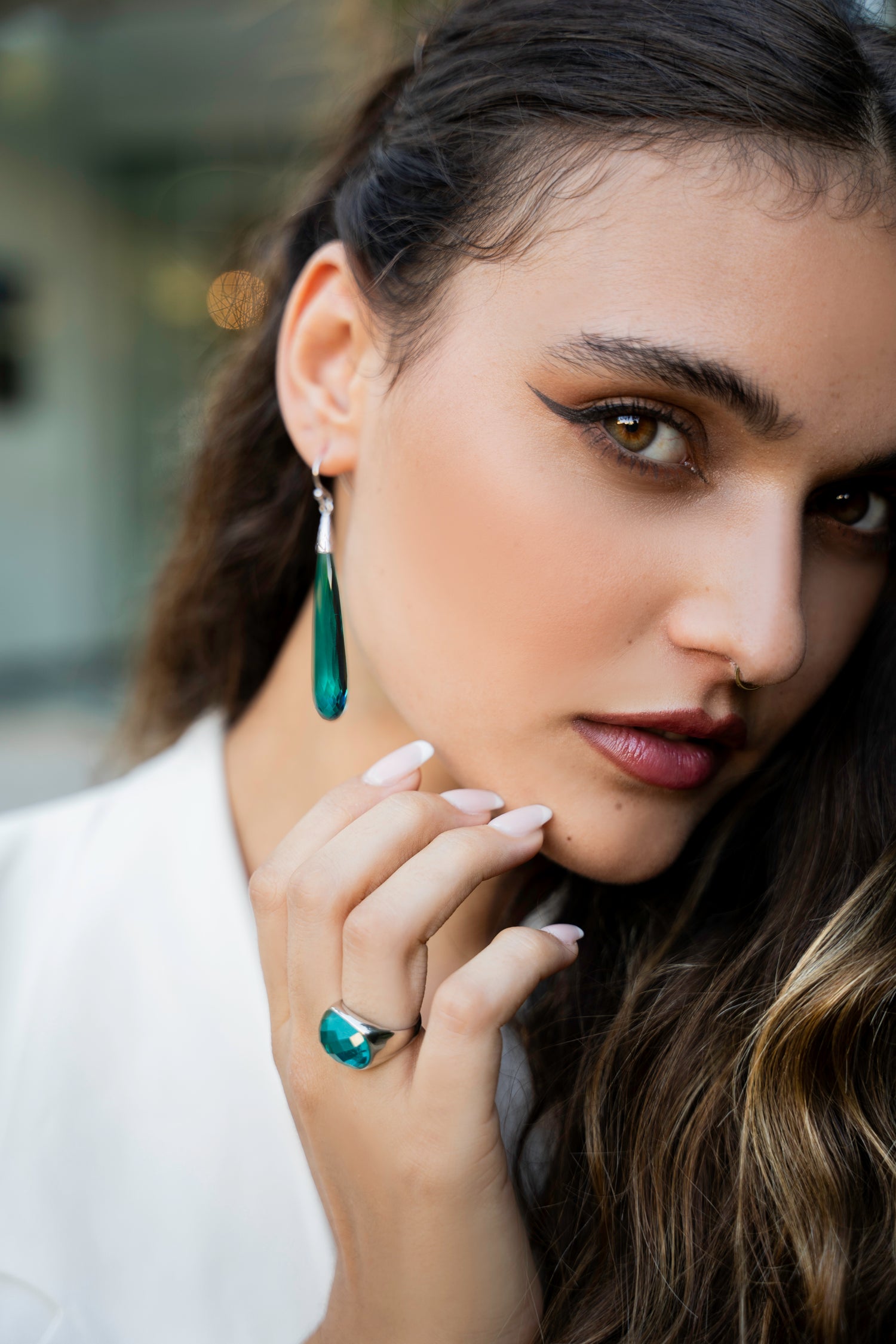 Model wearing jewelry earrings tourmaline quartz blue drop shape with the matching ring tourmaline quartz blue sterling silver